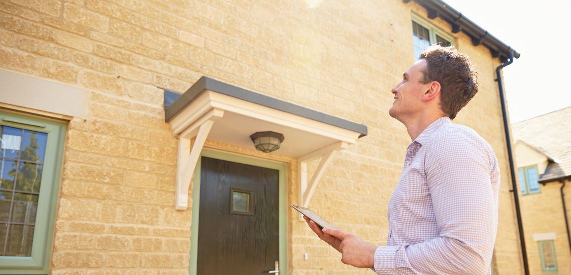 surveyor-in-front-of-house